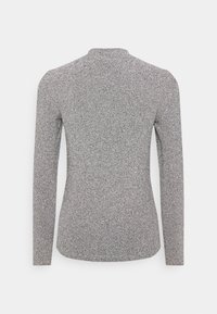 Long-sleeve top in a textured, metallic grey fabric with a close fit and a mock neckline, featuring subtle sparkle details.