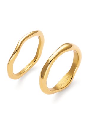 Twee onregelmatig gevormde gepolijste gouden ringen met gladde oppervlakken en de merknaam "SINGULARU" gegraveerd aan de binnenkant.