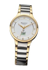 Montre-bracelet dorée et argentée avec un cadran blanc, des chiffres arabes et un affichage numérique à 6 heures. Elle possède un bracelet en acier inoxydable.