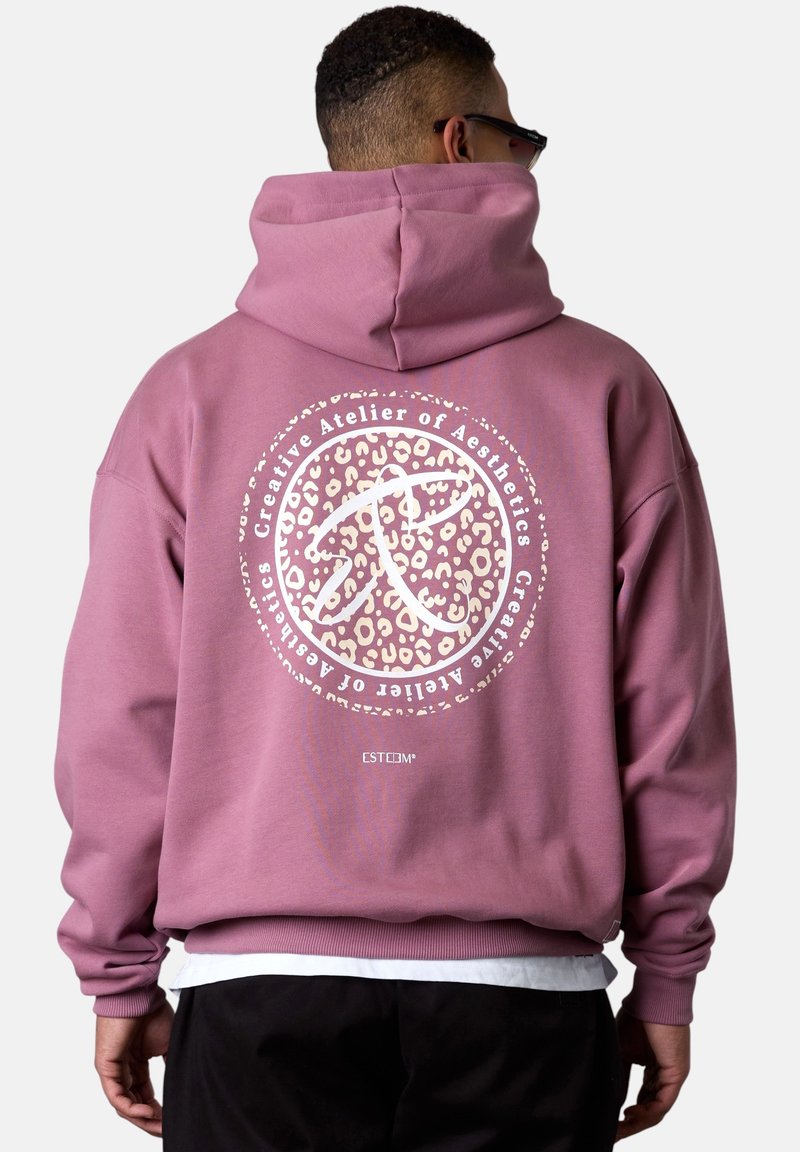 Pink hoodie with a large, circular graphic featuring a leopard print pattern and white text on the back. Soft texture and standard fit design.