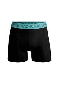 Melnā vīriešu bokseru apakšveļa ar tirkīza elastīgu jostu, uz kuras redzams teksts "MUCHACHOMOLO". Izgatavota no mīksta, stiepšanās auduma ērtībām.