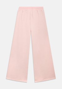 Svetloružové široké nohavice z mäkkej bavlnenej látky s elastickým pásom a hladkou textúrou, s jednoduchým dizajnom.