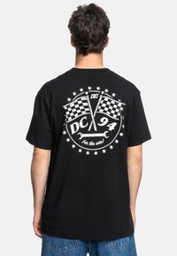 Black cotton t-shirt featuring a white graphic with checkered flags, circular design, and text "DC 94 for the win!" on the back.