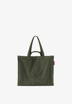 Dark green ribbed fabric tote bag with two long handles and a small red brand tag on the side.