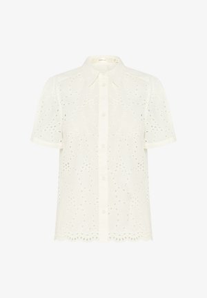 Witte korte mouwen shirt met een knoopsluiting aan de voorkant. Heeft ingewikkelde uitgesneden bloemmotieven en een golvende onderrand. Zacht, lichtgewicht stof.