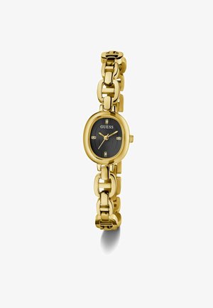 Gold watch with a round black dial and decorative links on the strap. Displays the brand "Guess" and features three small stones on the dial.