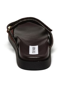 Brune læder flip-flop sandal med en flad, tekstureret fodseng og en robust sort ydersål. Har en guldfarvet hardware detalje og logo elementer.