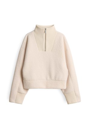 Fleece pullover in lichtbeige met een hoge, ribbelkraag en een halve rits. Kenmerken zijn de textuurstof en het cropped ontwerp met ribbels aan de mouwen.
