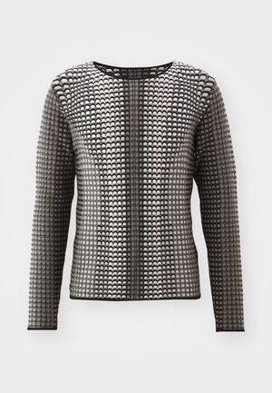 Dlouhý rukáv černobílý top s texturovaným vzorem malých kroužků a kulatým výstřihem, vyrobený z pružného materiálu.