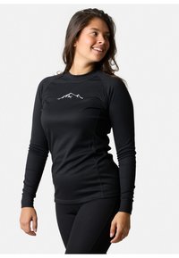 Black long-sleeve athletic top with ribbed texture and high neckline. Features a mountain graphic in white centered on the chest.