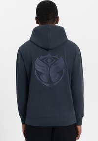 Dark gray hoodie featuring a large emblem on the back, depicting wings and an eye, with a textured fabric and ribbed cuffs.