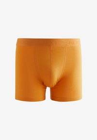 Oranžid puuvillased bokserpüksid bränditud elastse vöökohaga, tiheda istuvusega ja keskmise pikkusega jalgadega. Sile tekstuur ja lihtne disain.