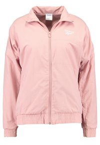 Light pink Reebok windbreaker jacket with a stand-up collar, elastic cuffs, and waistband, featuring a front zipper and logo detail.