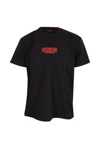 Černé bavlněné tričko s potiskem v roztrhaném stylu červeného loga "STRANGER THINGS" napříč hrudníkem. Design s kulatým výstřihem.