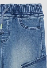 Denim joggers in een diepe blauwe tint, met een elastische tailleband met een trekkoord, een voorzak en een zachte, gestructureerde afwerking.