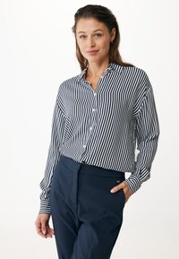 Striped button-up shirt in navy and white, long sleeves, collar, paired with tailored navy trousers. Smooth fabric, relaxed fit, classic design.