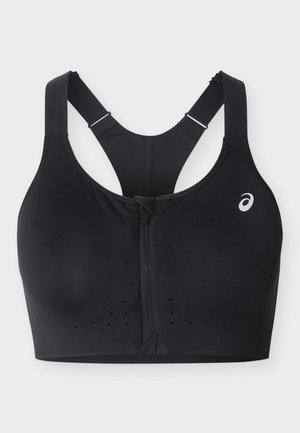 Black sports bra with front zipper, adjustable racerback straps, perforated ventilation, and small white logo on the left side.