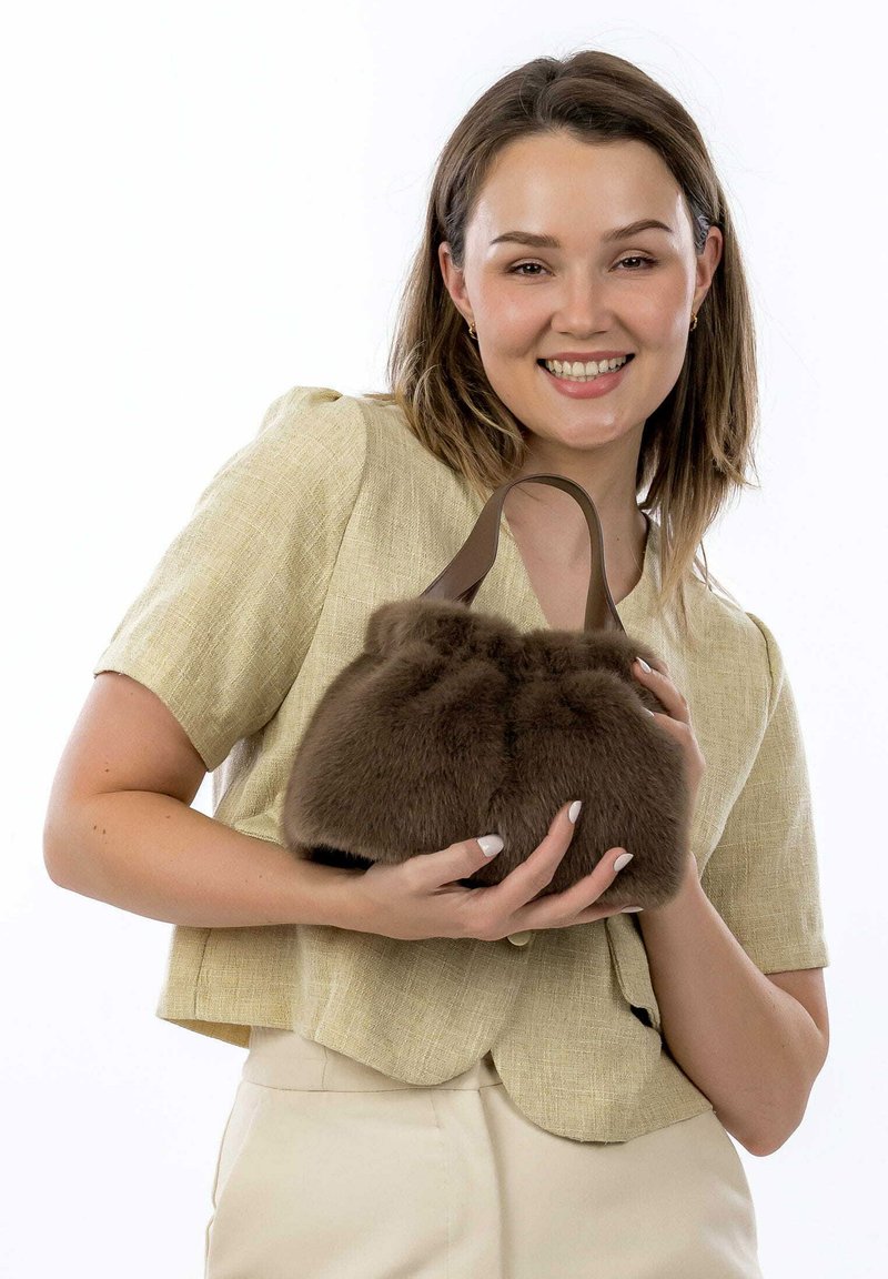 Brown faux fur handbag with a rounded, plush shape and a dark brown handle. Soft texture with a subtle sheen.