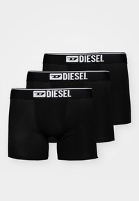 Black boxer briefs in a pack of three. Features a black waistband with white "DIESEL" branding. Smooth fabric with a fitted design.