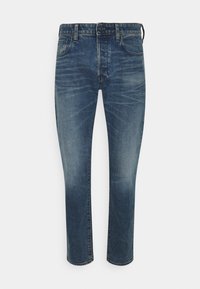 Modré džíny z denimu s úzkým střihem, středně vysokým pasem, pětikusovým designem, jemným vyblednutím a kontrastními švy.