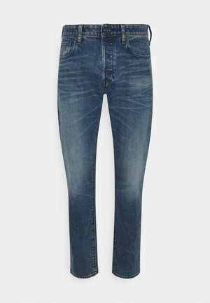 Blaue Jeans aus Denim mit slim Fit, mid-rise Taille, fünf Taschen, dezente Verfärbungen und kontrastierenden Nähte.