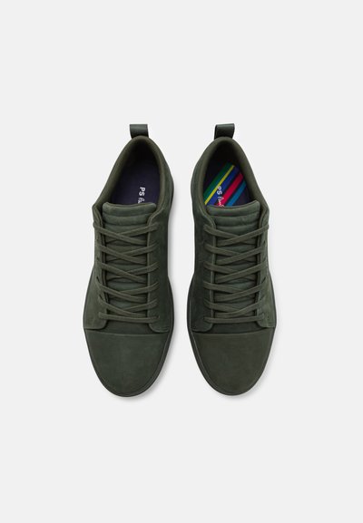 Dark green suede sneakers with a rounded toe, flat laces, and tonal stitching, featuring a colorful striped insole and pull tab.