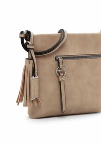 Beige leather handbag with a smooth texture, zipper closure, and attached tassel detail. Features black strap accents and silver hardware.