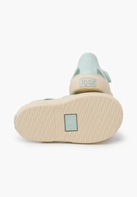 Light blue rubber sandals with a textured beige sole, featuring a back strap and embossed logo. Size 21 indicated on the heel.