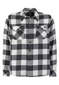 Svart och vit rutig flanellskjorta med långa ärmar, knappstängning fram, två bröstfickor och rundad nederkant. Mjuk tygkänsla.