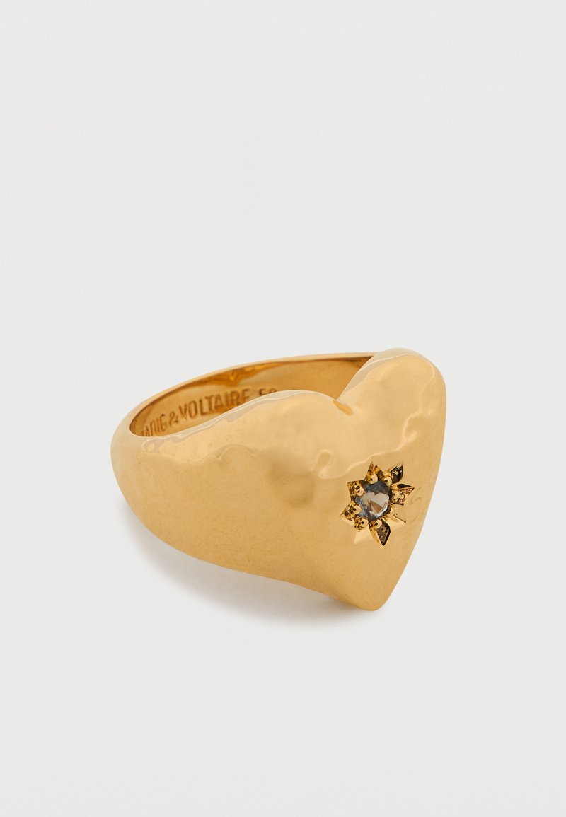 Anello a forma di cuore in oro con finitura lucida, caratterizzato da un dettaglio decorativo a forma di fiore con una pietra preziosa al centro.
