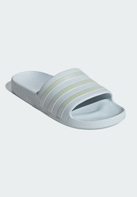 Light blue slide sandal with three textured stripes in a slightly darker shade. Features a soft foam footbed and a textured sole for grip.
