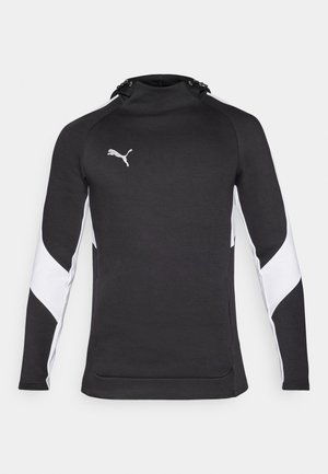 Zwarte sportieve hoodie met een hoge kraag, witte accenten op de mouwen en een klein logo in zilver. Zachte textuur, getailleerd ontwerp.