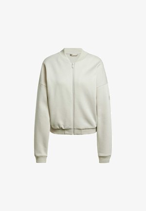 Chaqueta bomber de color beige claro con cremallera frontal, puños acanalados y cinturilla. Hecha de una tela suave con textura lisa y corte relajado.