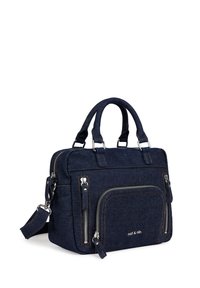 Denim handbag in dark blue with dual top handles, a detachable shoulder strap, multiple zippered pockets, and contrast stitching.