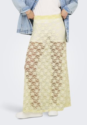 Jupe longue en dentelle jaune transparente avec des motifs floraux, une taille élastique et un design superposé pour plus de texture et de profondeur.
