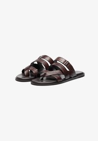 Brown leather sandals featuring three textured straps with a reptile pattern and a flat sole, designed for casual wear.