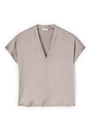 Beżowa bluzka z krótkim rękawem, dekoltem w serek i luźnym krojem, wykonana z lekkiego materiału, przedstawiona na płasko na białym tle.