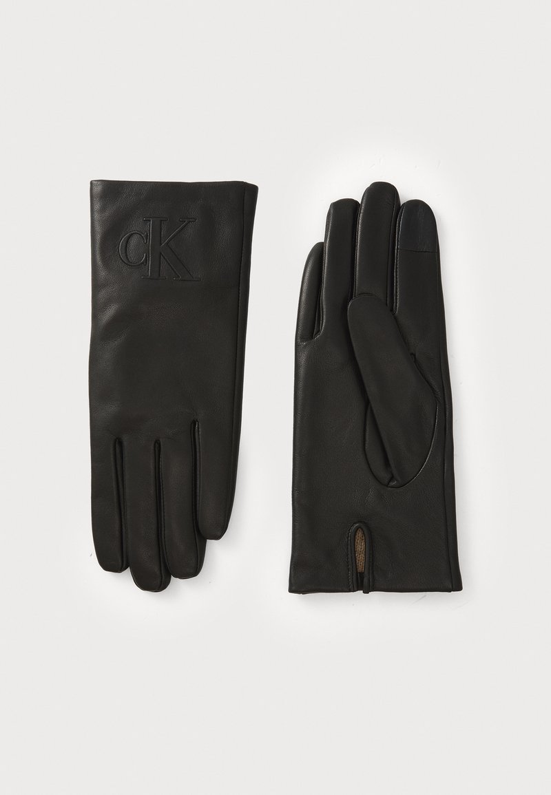 Black leather gloves with a smooth texture, featuring stitched details and an embossed 'CK' logo. Includes a small opening at the wrist.