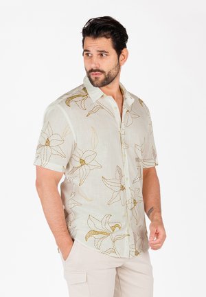 Kurzarmhemd aus leicht grünem Stoff mit goldenen Blumenstickereien. Verfügt über eine durchgehende Knopfleiste und eine lockere Passform.