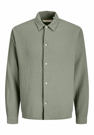 Hosszú ujjú, zsugorított menta zöld pamuting, gallérral és öt fehér gombbal az elején.