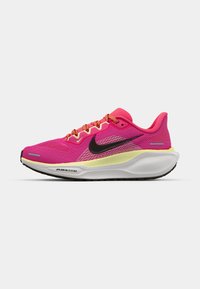 Pink athletic shoes with a breathable mesh upper, black Nike swoosh, bright orange laces, and a contrasting yellow midsole. White outsole.