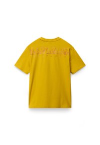 Yellow cotton t-shirt with short sleeves. Features a large, faded pink logo on the back. Standard crew neck design. Smooth texture.