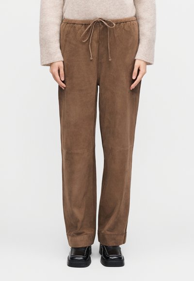 Barna velúr nadrág elasztikus derékrésszel és húzózsinórral, egyenes szárú kialakítással és minimális varrási részletekkel.