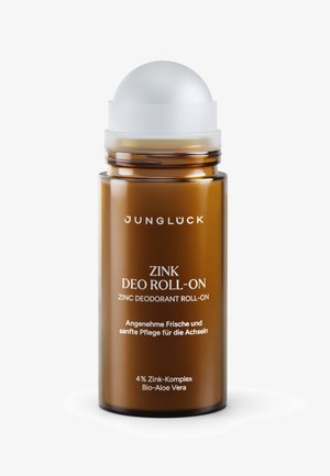 Braune Glastube mit Roll-On-Deodorant und weißem Deckel, beschriftet mit "Junglück Zink Deo Roll-On", enthält Zink und Aloe Vera.