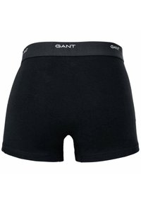 Boxer shorts neri in cotone con una texture liscia, dotati di un elastico in vita grigio scuro con il logo GANT. Nessun motivo o dettaglio visibile.