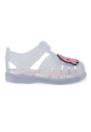 Sandale en jelly transparente avec un design de pieuvre rose, bout ouvert, multiples fentes verticales, strap ajustable et semelle intérieure blanche à motif.