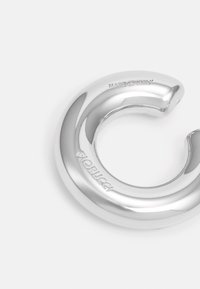 Silver, circular metal hook with a smooth, polished surface. Features embossed text "MADE IN ITALY" and "Fiorucci" on the side.