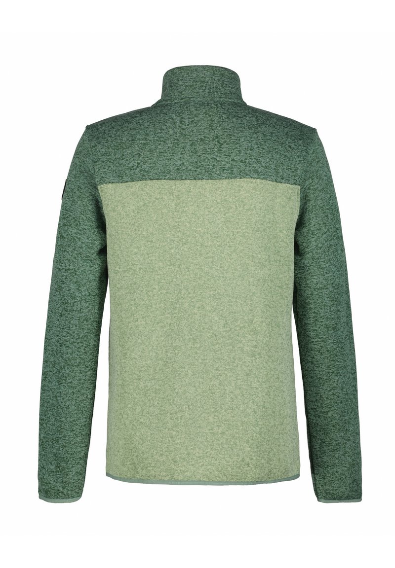 Giacca in pile con un design bicolore in verde scuro e chiaro, con colletto alto e tessuto testurizzato. La vista posteriore mette in evidenza la costruzione senza cuciture.