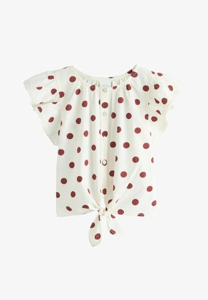 Bluză albă cu mâneci scurte, cu buline mari roșii, nasturi în față, mâneci bufante și nod legat la tiv.