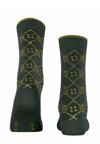 Grüne Socken mit einem Rautenmuster in Gelb, die florale Motive und ein strukturiertes Gewebe aufweisen. Knöchellang mit gerippten Bündchen.